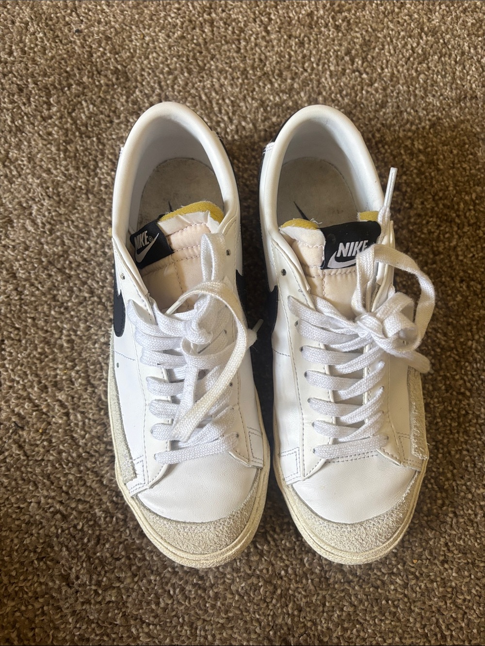 Nike White Sneakers with Black Swoosh and Yellow Tongue Accent